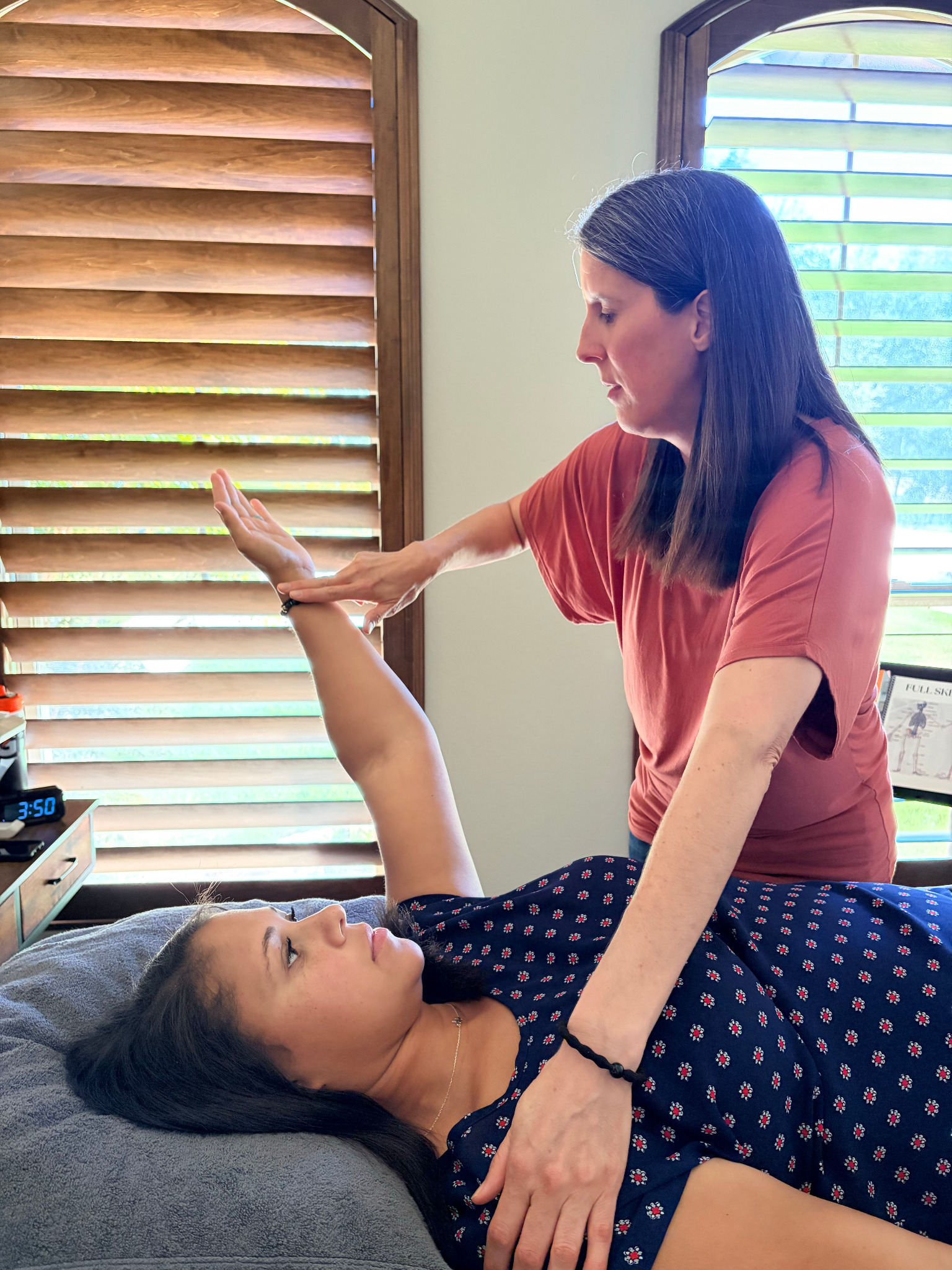 Katie performing hands-on Muscle ReActivation work with a client.